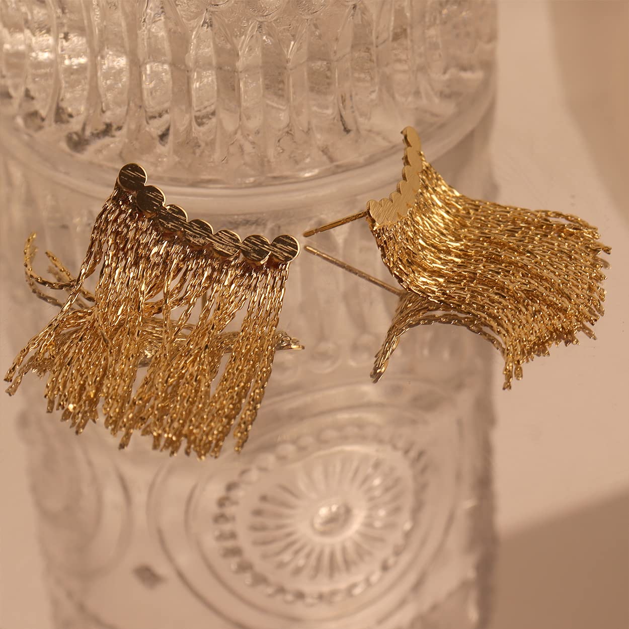 Long earrings with curved bar and tassel